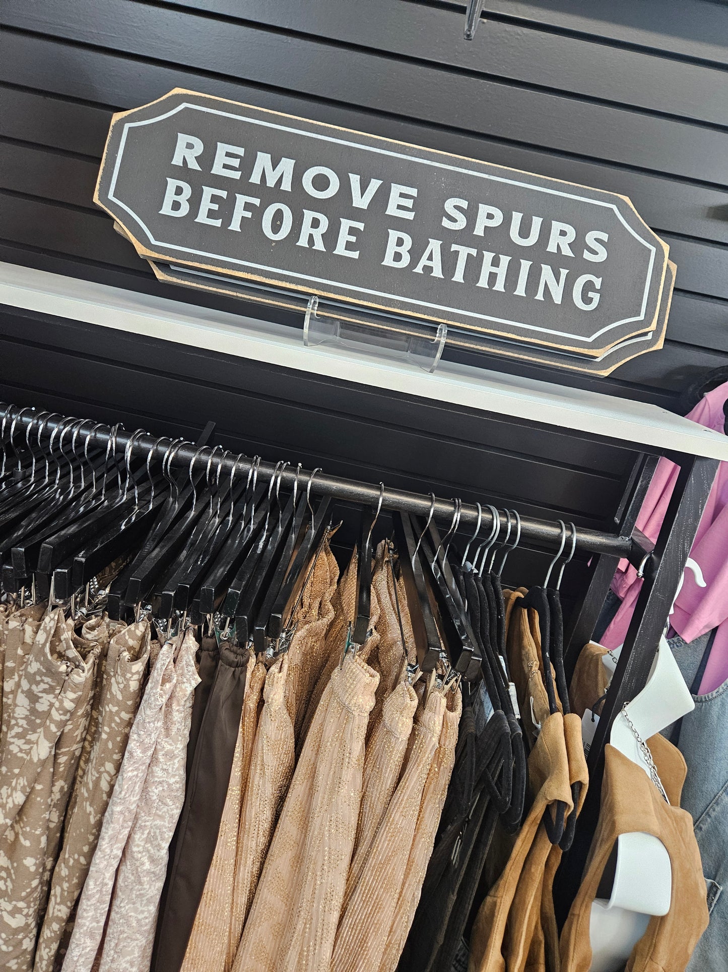Remove Spurs Before Bathing Sign