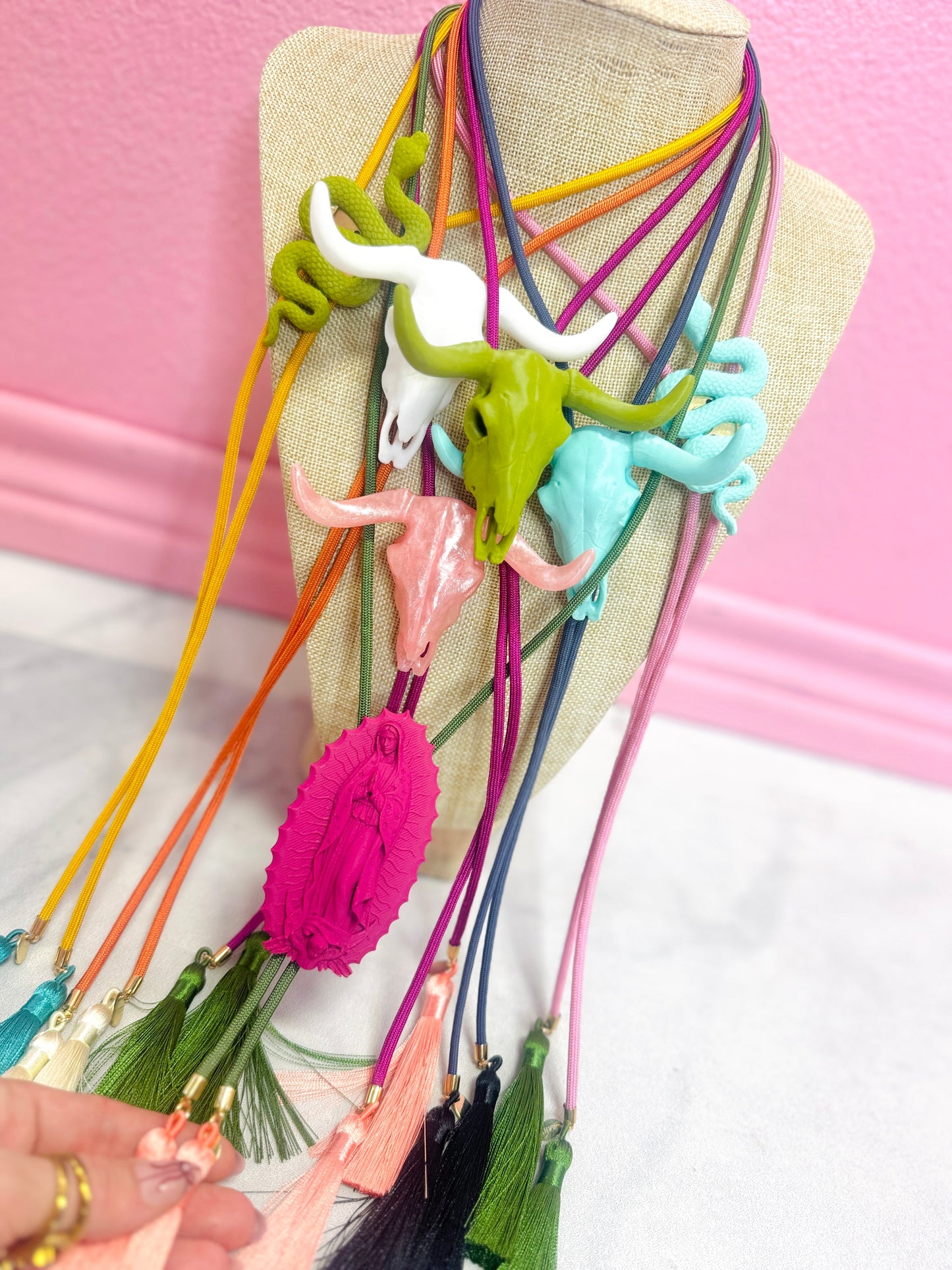 The Saint Glitterali Tassel Bolo